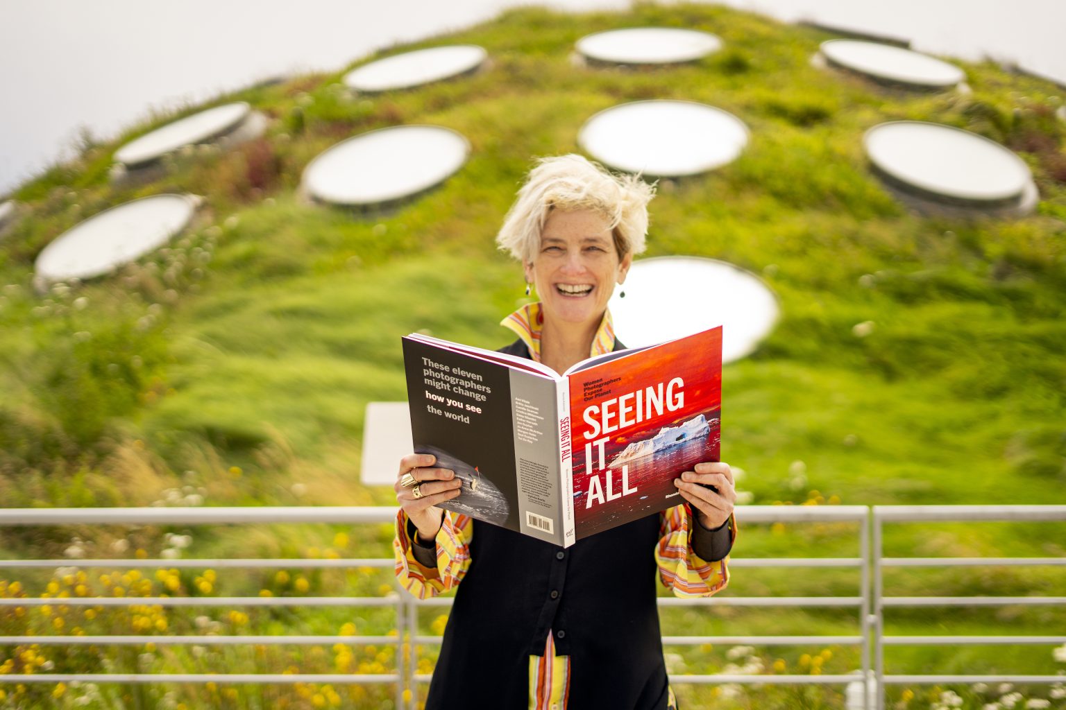 Alumna Rhonda Rubinstein on the Living Roof of the California Academy of Sciences, checking out an advance copy of my new book, Seeing It All: Women Photographers Expose Our Planet