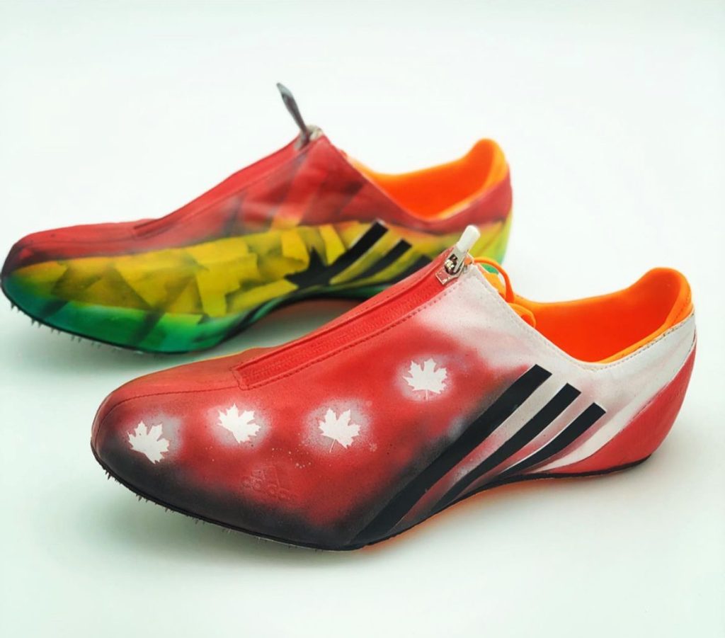 A pair of sneakers painted red, green, yellow, black and white to represent Ghana's national flag.