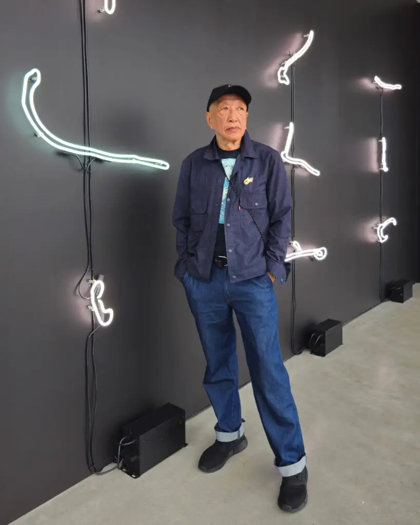 Artist Paul Wong standing in front of his art installation FUll Moon Polygon