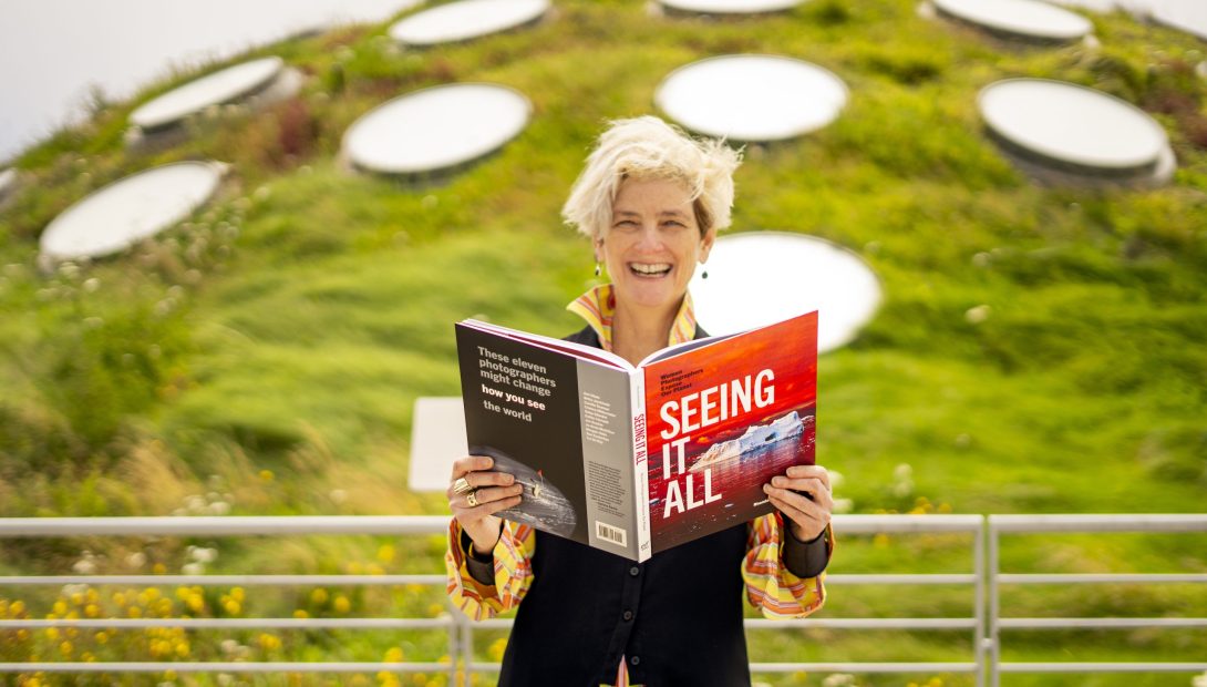 Alumna Rhonda Rubinstein on the Living Roof of the California Academy of Sciences, checking out an advance copy of my new book, Seeing It All: Women Photographers Expose Our Planet
