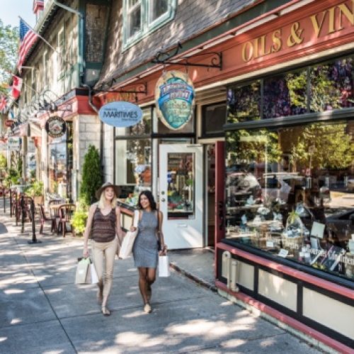 People walking past shops on a historic street in downtown Halifax